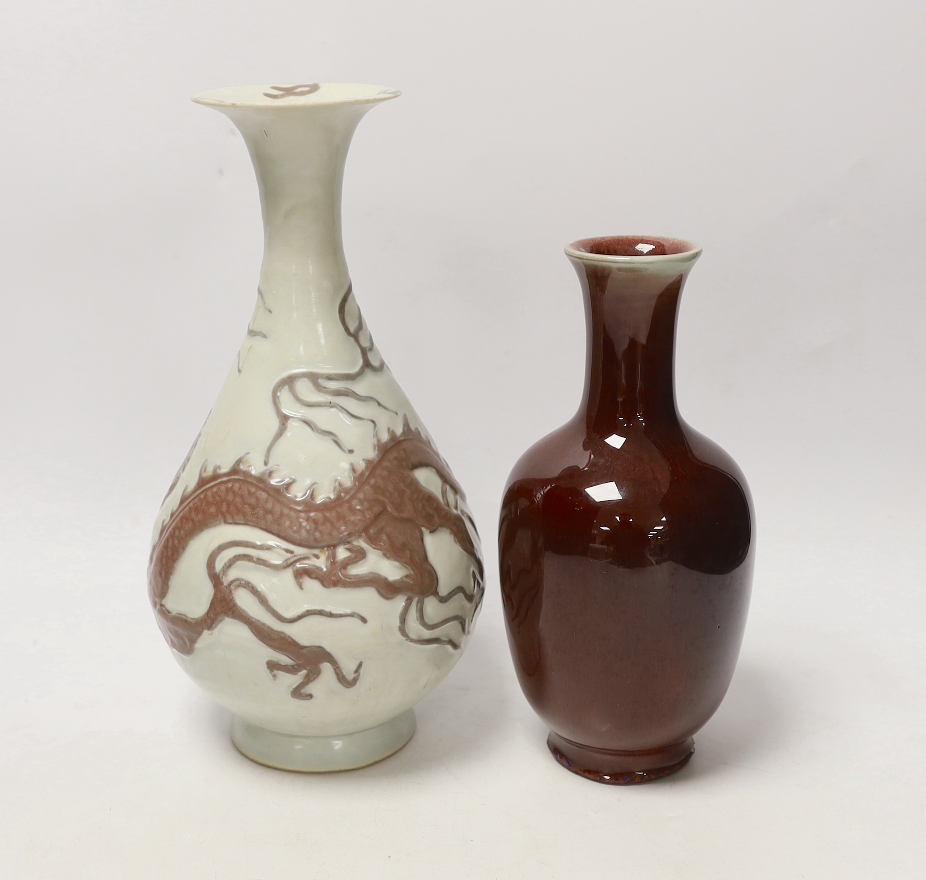 A Chinese sang de boeuf glaze vase and another copper red ‘dragon’ vase, tallest 26cm